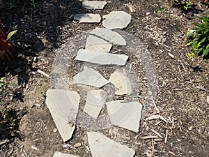 Grey stepping stones in brown mulch