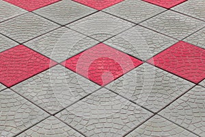 Grey stone diagonal abstract grey pattern pavement floor tile city street texture background with red paint pink color