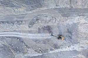 Grey stone quarry pit from aerial bird`s eye view