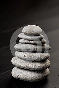 Grey Stones Balanced on the black background