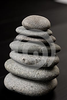 Grey Stones Balanced on the black background