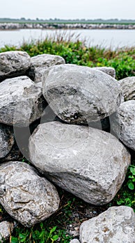 Grey stones stacked near water, nature background photo