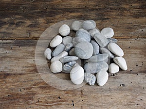 Grey stones on a wooden table