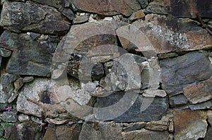 A grey stonewall close up