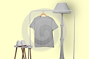 Grey t-shirt hanging on rack display  on white background