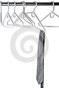 A grey tie on a clothes hanger