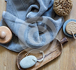 Grey towel with body brush, rustic footcare accessory, top view