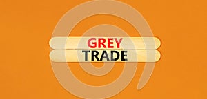 Grey trade symbol. Concept words Grey trade on wooden sticks. Beautiful orange table orange background. Business grey trade
