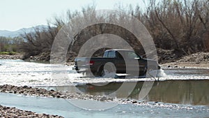 Grey truck crossing the river