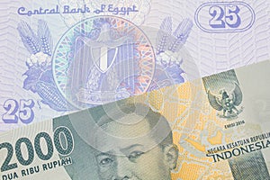 A grey two thousand Indonesian rupiah bank note paired with a blue twenty five piastre bank note from Egypt.