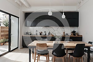 grey wall chopping board and wooden table black pillow black lantern with black white modern kitchen dining room corner
