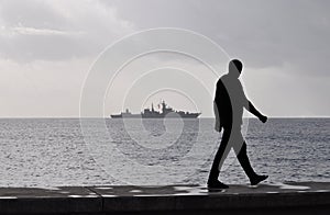 The grey warship on the sea.