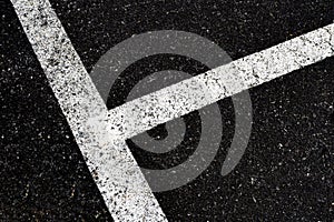 Grey with white line angle on the road and small rock, high angle view dirty white line on surface of old asphalt in countryside