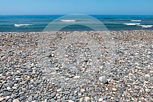Grey and white pebble beach on the mediterranean sea