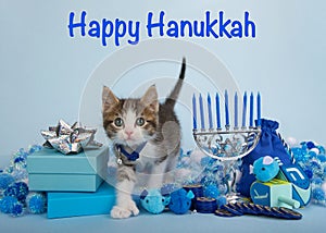 Grey and white polydactyl kitten in Hanukkah scene with text Happy Hanukkah