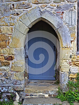 Grey Wooden Door Under Stone Archway