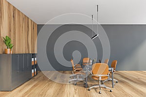 Grey wooden office room with shelf for folders, brown chairs and table