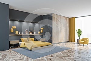 Grey and wooden sleeping room with bed on carpet and decoration