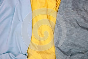 Grey and yellow fabric top view. Colored textile photo texture. Folded fabric with wrinkles for pattern mockup. Blank textile