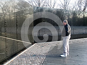 Greyhaired Man Standing in Front of Vietman Memorial in Washington DC March 2007