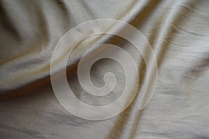 Greyish gold napped fabric in soft folds