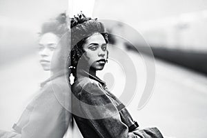 Greyscale portrait of black girl at the metro station