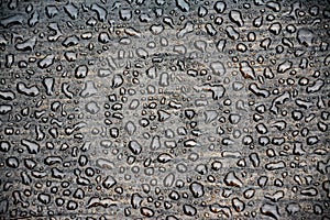 Greyscale shot of the drops of water on a wooden surface - perfect for a background