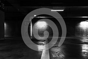 Greyscale shot of an empty underground parking lot