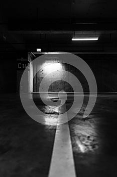 Greyscale shot of an empty underground parking lot