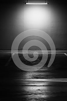 Greyscale shot of an empty underground parking lot