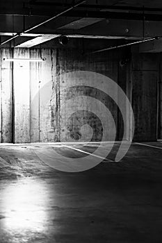 Greyscale shot of an empty underground parking lot