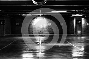 Greyscale shot of an empty underground parking lot