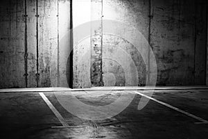 Greyscale shot of an empty underground parking lot