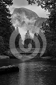 Greyscale shot of the Sentinal Bridge with the Half Dome batholith in the background, Yosemite