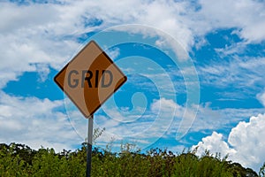 Grid road sign with blue cloudy sky