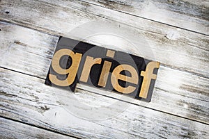 Grief Letterpress Word on Wooden Background