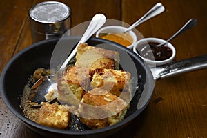 A fresh cooked semolina pancake in a pan.