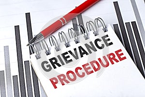 GRIEVANCE PROCEDURE text written on notebook with pen on chart