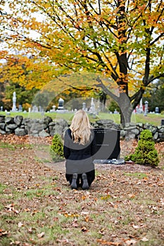 Grieving woman in cemetery