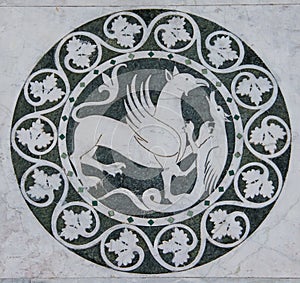 Griffin mythical animal in a decorative circle on the Chiesa dei Santi Giovanni e Reparata