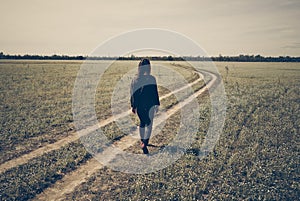 A gril walk sadly on wheel track photo