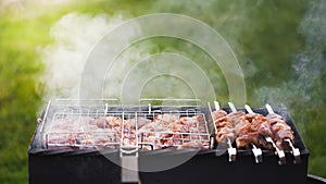 Grill barbecue meat on a brazier with smoke, green grass background photo