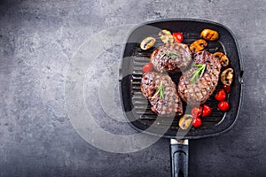 Grill beef steak. Portions thick beef juicy sirloin steaks on grill teflon pan or old wooden board