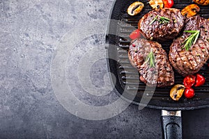 Grill beef steak. Portions thick beef juicy sirloin steaks on grill teflon pan or old wooden board