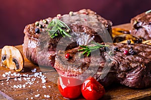 Grill beef steak. Portions thick beef juicy sirloin steaks on grill teflon pan or old wooden board photo