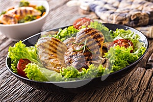 Grill Chicken Breast. Roasted and grill chicken breast with lettuce salad tomatoes and mushrooms