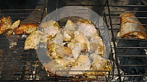 Grill chicken wings, cook meat and fish over a fire