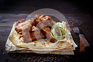 Grill dishes for the restaurant menu. Wooden background. Pork ribs with sauce and pita