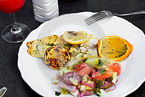 Grill fish with salad and citrus