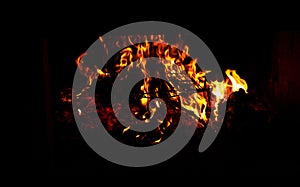 A grill is heated over a wooden fire